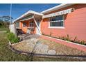 Front entrance with stone pathway and landscaping at 130 Virginia Ct, Englewood, FL 34223