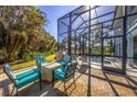 Covered patio with seating area and views of the pool and surrounding landscape at 13104 Via Cassia, Placida, FL 33946