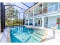 Enclosed pool area with a large pool, seating area, and lush greenery at 13104 Via Cassia, Placida, FL 33946