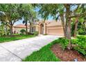 One-story house with a tile roof, driveway, and green lawn at 13123 Preserve Ct, Port Charlotte, FL 33953