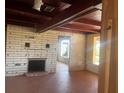 Unfinished living room with brick fireplace and tiled floors at 138 Winson Ave, Englewood, FL 34223