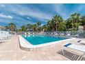 Inviting community pool with ample lounge chairs under sunny skies at 1531 Placida Rd # 1-204, Englewood, FL 34223