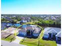 Aerial view of single-Gathering home on canal with lush landscaping at 15336 Lakeland Cir, Port Charlotte, FL 33981