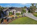 Single story home with landscaped yard and two car garage at 15375 Taurus Cir, Port Charlotte, FL 33981