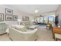 Bright living room with comfy seating, access to balcony, and tiled floors at 1651 Beach Rd # 212, Englewood, FL 34223