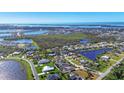 Aerial view of a waterfront community with numerous houses and lakes at 2271 Paraiso Ct, Englewood, FL 34224