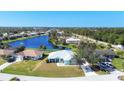 Aerial view showing a single-Gathering home near a lake in a residential area at 2271 Paraiso Ct, Englewood, FL 34224