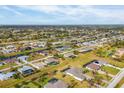 Property's aerial view showcasing neighborhood and canal at 241 Mariner Ln, Rotonda West, FL 33947