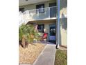 Condo unit entrance with small patio and American flag at 25225 Rampart Blvd # 102, Punta Gorda, FL 33983