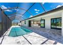 Relaxing pool and patio area with a covered lanai at 35 Broadmoor Ln, Rotonda West, FL 33947
