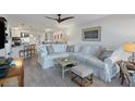 Open concept living room and kitchen with white furniture at 5856 Gasparilla Rd # M27, Boca Grande, FL 33921