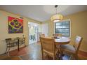 Dining area with table, chairs, and view into kitchen at 66 Boundary Blvd # 282, Rotonda West, FL 33947