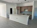 Modern kitchen features a large island, sleek countertops, mosaic backsplash, and custom cabinetry at 7351 Lighthouse St, Englewood, FL 34224