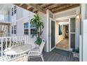 Private deck with white metal table and chairs, offering peaceful outdoor space at 7482 Palm Island Dr # 2511, Placida, FL 33946