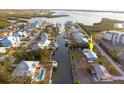 Aerial view highlighting a charming waterfront home with canal access at 9230 Griggs Rd, Englewood, FL 34224
