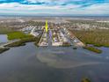 Aerial view of a canal front property showing a house and surrounding neighborhood at 9230 Griggs Rd, Englewood, FL 34224