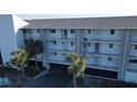 Condo building exterior showcasing multiple units and parking at 1401 S Mccall Rd # 306B, Englewood, FL 34223