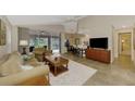 Open living space with a view of the kitchen and patio at 14049 Willow Glen Ct # 242, Port Charlotte, FL 33953