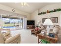 Bright living room with high ceilings and sliding glass doors leading to the pool at 171 Medalist Rd, Rotonda West, FL 33947