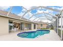 Screened-in pool area with ample seating and a lovely pool at 171 Medalist Rd, Rotonda West, FL 33947