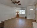 Living room with tile floor, ceiling fan, and window at 1860 Bluebird Ln, Englewood, FL 34224