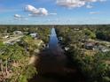 Wide canal view showing waterfront properties and lush greenery at 2397 Cannolot Blvd, Port Charlotte, FL 33948