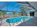 Gorgeous screened-in pool and spa, offering a serene outdoor retreat with lovely water views at 26098 Constantine Rd, Punta Gorda, FL 33983