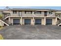 Condo building showcasing a single unit's entrance and attached garage at 4260 Placida Rd # 14C, Englewood, FL 34224