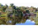 Scenic view of a canal with lush tropical vegetation and waterfront homes at 4656 Pompano St, Placida, FL 33946