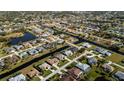An aerial perspective of homes with pools, canals, and lush green lawns at 47 Sportsman Ln, Rotonda West, FL 33947