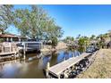 Private dock with boat lift extending into a tranquil canal at 560 Sandlor Dr, Englewood, FL 34223