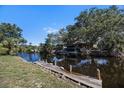 Private wooden dock on the canal, offering waterfront access and scenic views at 560 Sandlor Dr, Englewood, FL 34223