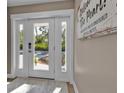 Bright and welcoming foyer entryway with a view to the front yard at 7064 Baypine Ln, Englewood, FL 34224