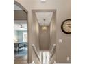 View of the staircase leading downstairs from the second floor at 7064 Baypine Ln, Englewood, FL 34224