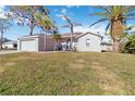 Inviting single-Gathering home with lush green lawn, palm trees and an attached garage at 792 Lehigh Rd, Venice, FL 34293
