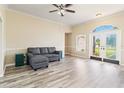Spacious living room with a gray sectional sofa and wood-look floors at 792 Lehigh Rd, Venice, FL 34293