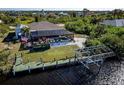 An aerial view showcasing a home with a pool, boat dock, and lush tropical surroundings at 9300 Miami Cir, Port Charlotte, FL 33981