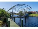 Covered boat dock with lift, perfect for boating enthusiasts at 9300 Miami Cir, Port Charlotte, FL 33981