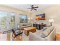 Bright living room featuring comfortable sofas, hardwood floors, and a large TV at 10300 Coral Landings Ct # 91, Placida, FL 33946
