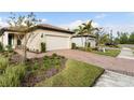 House exterior showcasing a beige facade, white garage door, and brick walkway at 2759 Lavandula Ct, North Port, FL 34289