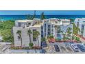 Oceanfront condo building with parking and lush landscaping at 2950 N Beach Rd # A315, Englewood, FL 34223