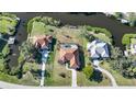 Aerial view showcasing a home's location on a waterfront lot with pool and surrounding properties at 4658 Arlington Dr, Placida, FL 33946