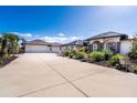 A beautiful house with a long driveway, landscaped yard, and palm trees under a clear sky at 646 Boundary Blvd, Rotonda West, FL 33947