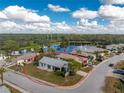 House with a lake view in a residential community at 691 Linden Dr, Englewood, FL 34223