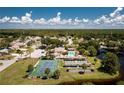Aerial view of community pool, tennis, and shuffleboard courts at 691 Linden Dr, Englewood, FL 34223