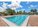 Community pool with brick deck and lounge chairs at 691 Linden Dr, Englewood, FL 34223