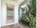 Open front door leads to a tiled entryway with a view into the living room at 9 Bunker Ct, Rotonda West, FL 33947