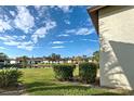View of condo community with pond and lush greenery at 524 Pine Hollow Cir # 524, Englewood, FL 34223