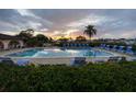 Relaxing community pool with plenty of lounge chairs at sunset at 149 Englewood Isles Pkwy # 606, Englewood, FL 34223