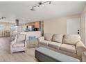 Open living room and kitchen with light flooring and neutral colors at 1493 Janet Pl, Englewood, FL 34223